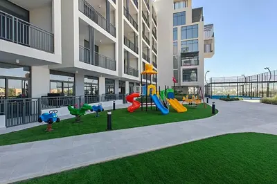 a playground in the middle of a apartment building at TOP Location and Work and Chill near Miracle Garden in Dubai