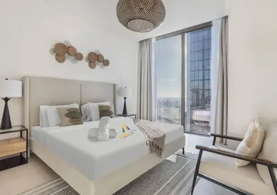 a white bedroom with a large bed and a large window at Fully Furnished 2 Bed in Sobha Creek Vista Reserve, Hosted by Desert City Stays in Dubai