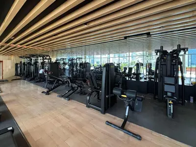a gym with a row of treadmills and machines at Frank Porter - Bella Rose in Dubai
