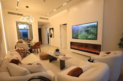a living room with a couch and a fireplace at VIP Experience Dubai Nad Al Sheba at Prime Views- Opposite Al Meydan Hotel- Modern Luxury Apartment in Dubai