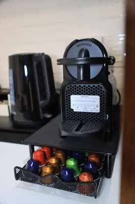 a coffee maker sitting on top of a shelf at VIP Experience Dubai Nad Al Sheba at Prime Views- Opposite Al Meydan Hotel- Modern Luxury Apartment in Dubai
