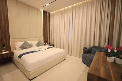a bedroom with a bed and a couch and a chair at VIP Experience Dubai Nad Al Sheba at Prime Views- Opposite Al Meydan Hotel- Modern Luxury Apartment in Dubai