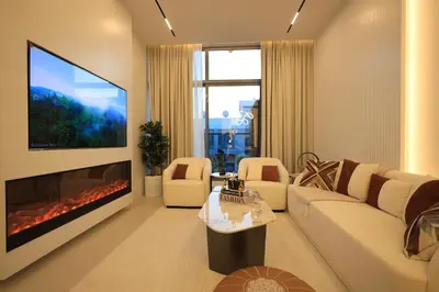 a living room with a couch and a fireplace at VIP Experience Dubai Nad Al Sheba at Prime Views- Opposite Al Meydan Hotel- Modern Luxury Apartment in Dubai