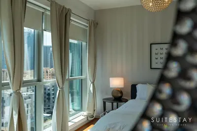 a bedroom with a bed and large windows at One Bed with Burj Khalifa View in Dubai