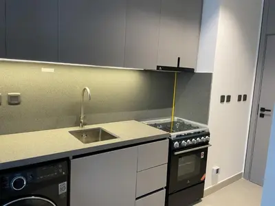 a small kitchen with a stove and a sink at MAG 960 Stylish Luxury Apartment 6 Minutes to Burj Khalifa with Complimentary Guest Welcome Pack in Dubai
