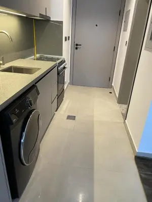 a kitchen with a washing machine and a sink at MAG 960 Stylish Luxury Apartment 6 Minutes to Burj Khalifa with Complimentary Guest Welcome Pack in Dubai