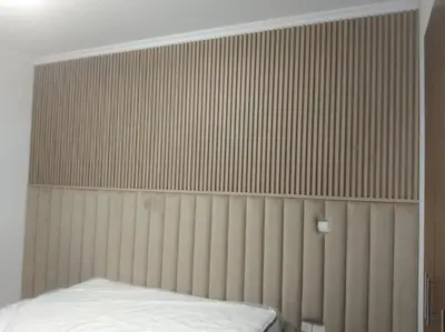 a bed in a room with a wall at 3 bedroom Villa Downtown in Dubai