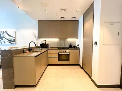 a kitchen with a sink and a stove top oven at Chic 1-Bedroom with Epic Burj Khalifa Views in Dubai