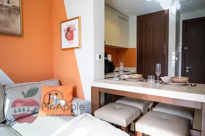 a kitchen with a bar with stools and a table at 1BR With Burj Khalifa View and Accomodates 4 People in Dubai