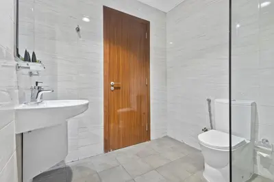 a white bathroom with a toilet and a sink at Premium 1 bedroom Apartment near Dubai Mall in Dubai