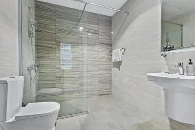 a bathroom with a shower and a toilet and a sink at Premium 1 bedroom Apartment near Dubai Mall in Dubai