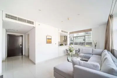 a living room with a couch and a table at Frank Porter - Damac Cour Jardin in Dubai