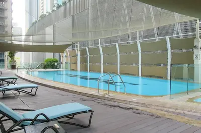 a large swimming pool inside of a building at Frank Porter - Damac Cour Jardin in Dubai