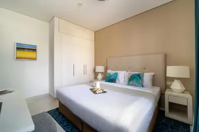 a hotel room with a bed with a tray on it at Frank Porter - Damac Cour Jardin in Dubai