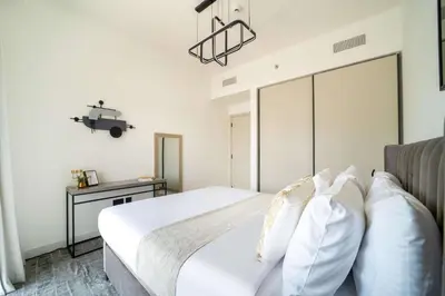 a bedroom with a white bed with white pillows at Frank Porter - Marina Vista Tower 2 in Dubai