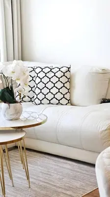 a living room with a white couch and a table at Luxury 2BR Carson Tower B Apt in Dubai