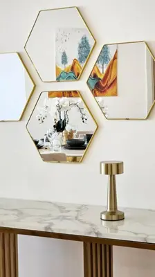 a mirror on a wall with a table and a lamp at Luxury 2BR Carson Tower B Apt in Dubai
