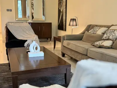 a living room with a couch and a coffee table at Dubai Apartment in Meydan in Dubai