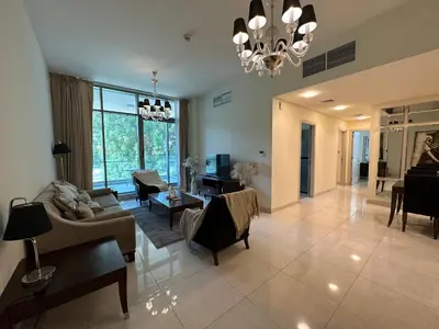 a living room filled with furniture and a chandelier at Dubai Apartment in Meydan in Dubai