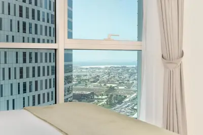 a view of a city from the window of a skyscraper at Lux BnB I Executive Tower I Ocean View in Dubai