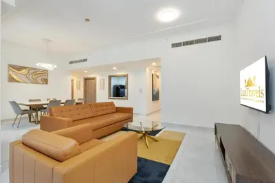 a living room with a couch and a table at Lux BnB I Executive Tower I Ocean View in Dubai