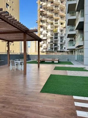 a patio with a table and chairs on a building at Cozy Studio in JVC in Dubai