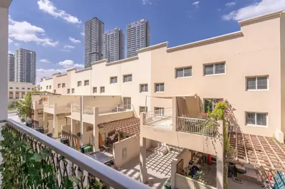 a balcony view of a building with tall buildings at Bright & Airy Studio in JVC in Dubai