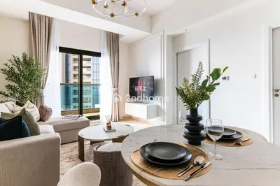 a living room with a table and a couch at Newly Furnished Unit in Elite, Business Bay in Dubai