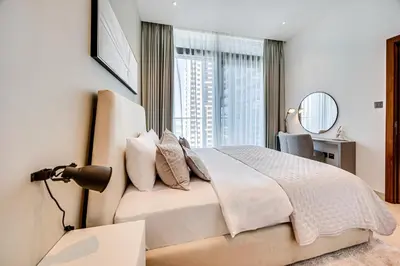 a bedroom with a bed and a large window at Brand new 1 bedroom in Marina gate 2, Dubai Marina in Dubai
