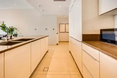 a kitchen with white cabinets and a sink at Brand new 1 bedroom in Marina gate 2, Dubai Marina in Dubai