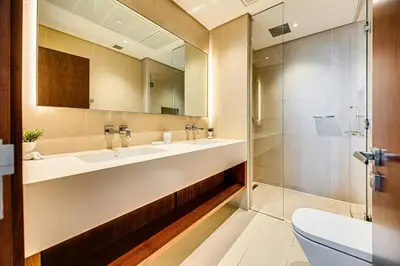 a bathroom with two sinks and a shower at Brand new 1 bedroom in Marina gate 2, Dubai Marina in Dubai