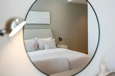 a mirror reflection of a bed in a bedroom at Brand new 1 bedroom in Marina gate 2, Dubai Marina in Dubai