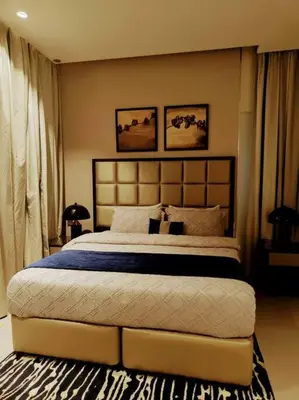 a bedroom with a large bed in a room at Luxury 1BR Majestine Apartment in Dubai