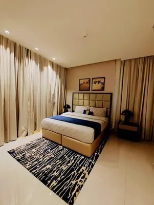 a bedroom with a large bed and a rug at Luxury 1BR Majestine Apartment in Dubai