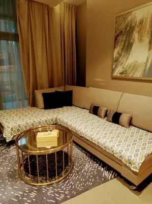 a living room with a couch and a glass table at Luxury 1BR Majestine Apartment in Dubai
