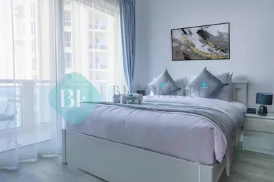 a white bed in a room with a window at Bloomfields Stu Lago With Vista Sea View in Dubai