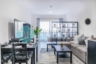 a living room with a couch and a table at Bloomfields Stu Lago With Vista Sea View in Dubai