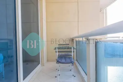 a glass door with a chair in a room at Bloomfields Stu Lago With Vista Sea View in Dubai