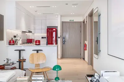 a kitchen and living room with a red refrigerator at 2035-Inspired 1BR - JVC Dubai Near Burj Khalifa in Dubai