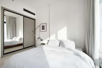 a bedroom with a large mirror and a bed at 2035-Inspired 1BR - JVC Dubai Near Burj Khalifa in Dubai