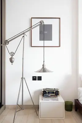 a lamp in a living room with a white wall at 2035-Inspired 1BR - JVC Dubai Near Burj Khalifa in Dubai