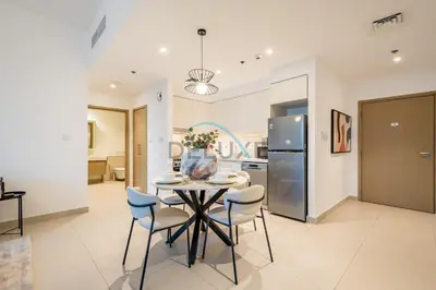 a kitchen and dining room with a table and chairs at Classy 1BR Apartment at Creek Horizon Tower 1, Dubai Creek Harbour by Deluxe Holiday Homes in Dubai