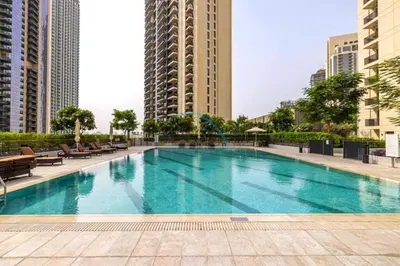 a large swimming pool in a city with tall buildings at Classy 1BR Apartment at Creek Horizon Tower 1, Dubai Creek Harbour by Deluxe Holiday Homes in Dubai