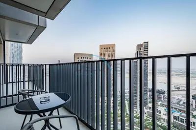 a desk on a balcony with a view of the city at Classy 1BR Apartment at Creek Horizon Tower 1, Dubai Creek Harbour by Deluxe Holiday Homes in Dubai