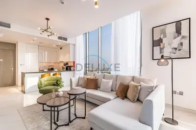 a living room with a white couch and a table at Stunning 1BR Apartment in District One Phase III, Mohammed Bin Rashid by Deluxe Holiday Homes Al Maktoum City in Dubai