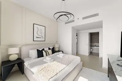 a white living room with a couch and a table at Silkhaus Full Burj Khalifa Views in Downtown in Dubai