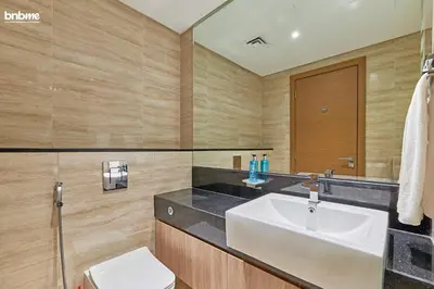 a bathroom with a sink and a toilet at bnbmehomes - Urban Oasis by Missoni in Dubai