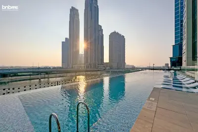 a pool in the middle of a city with tall buildings at bnbmehomes - Urban Oasis by Missoni in Dubai