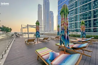 a group of lounge chairs and umbrellas on a roof at bnbmehomes - Urban Oasis by Missoni in Dubai