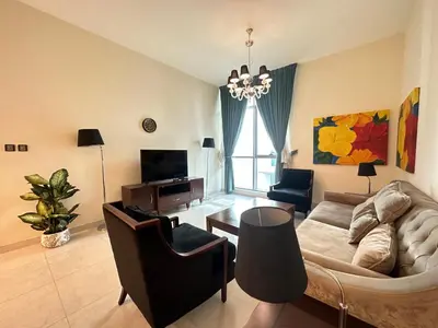 a living room with a couch and a table at Stunning 1-Bedroom in The Polo Residence, Meydan in Dubai
